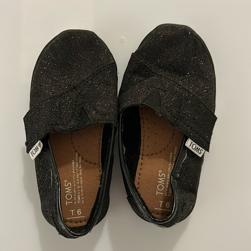 Worn once Toms sparkly black classic slip ons, size 6 little kid
